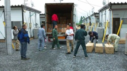 Volunteers bringing supplies into the temporary housing