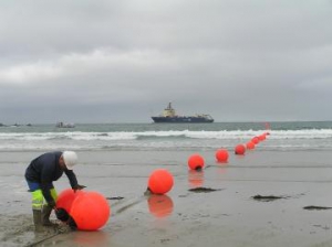 Workers begin laying the ACE submarine cable in Penmarc'h, France, October 2011