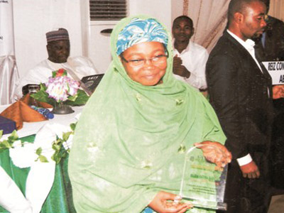 Woman holding plaque from Junior Achievement