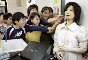 Japanese students look at robot teacher